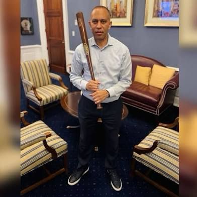 A tough guy with a bat waiting for mom after batting practice 
