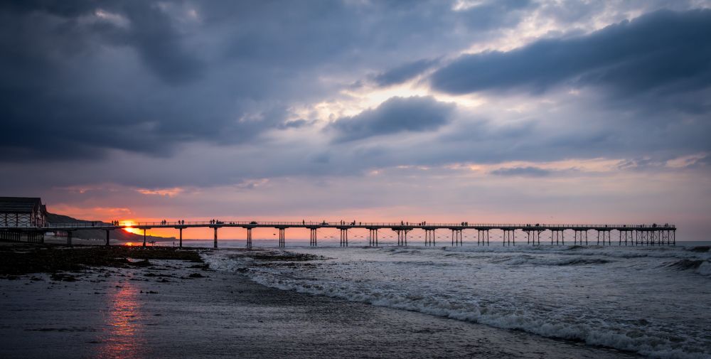 A photograph of Saltburn Pier at sunset.