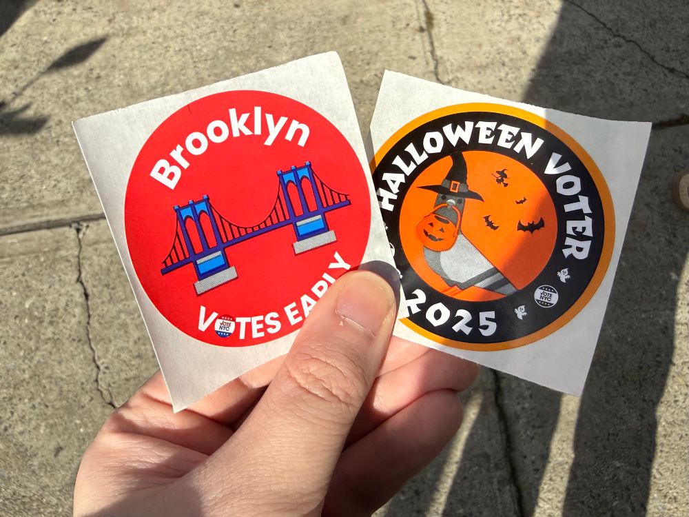 Photo of two NYC voting stickers, one for voting early and the other for voting on Halloween specifically.