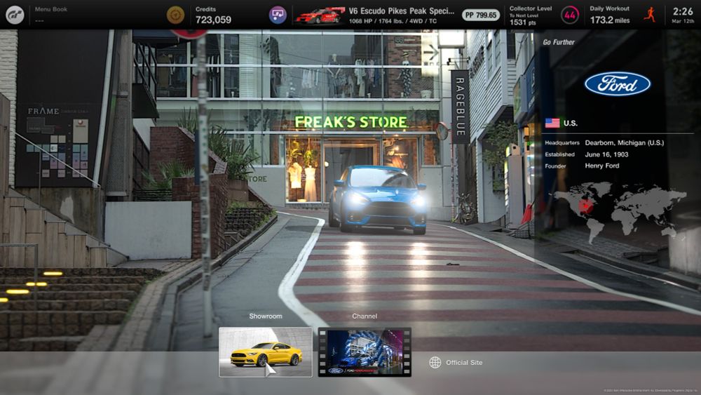 A screenshot from the 2022 video game, Gran Turismo 7.

In it, the OP is in Brand Central, specifically browsing the splash page for the in-game Ford dealership. In a demonstration showcasing the prowess of those aforementioned Ford vehicles, a car passes by a building called...

Freak's Store.