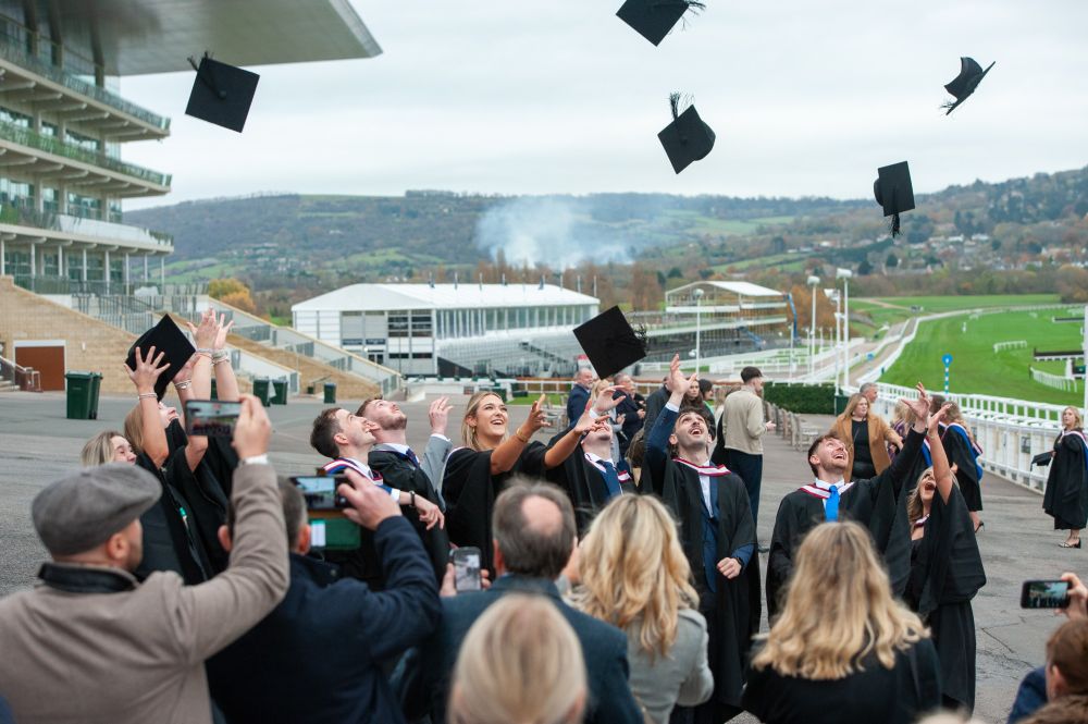 A group of grads throwing their caps in the air