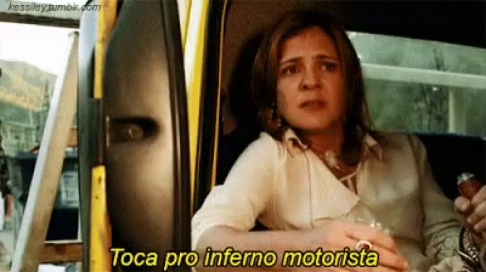 a woman is sitting in a car with the words toca pro inferno motorista on the bottom