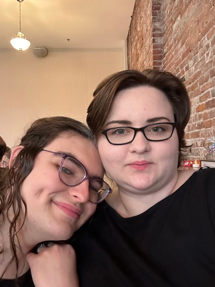 Two married bisexuals dolled up at a wedding reception 
