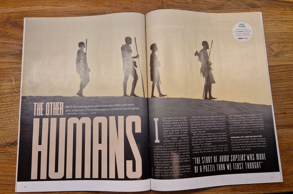 Photo of first pages in story called "The Other Humans". Image is people in silhouette walking along a ridge. They have spears. 