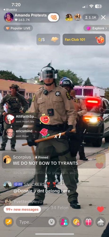 Police cars pushing forward behind the line of state police
