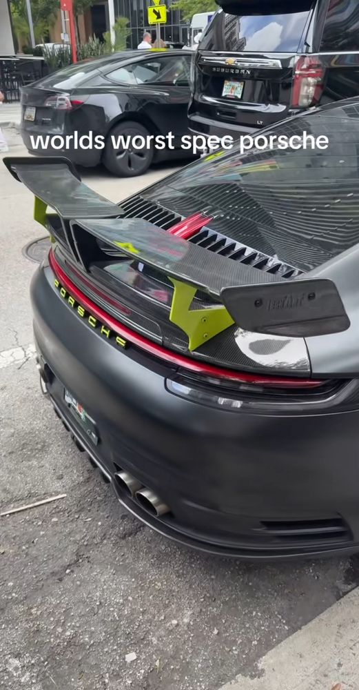 Rear of the 912 shows dual exhaust and a large wing that also has neon yellow accents. It looks like this car was spec’d out OEM (really expensive) not modified. 