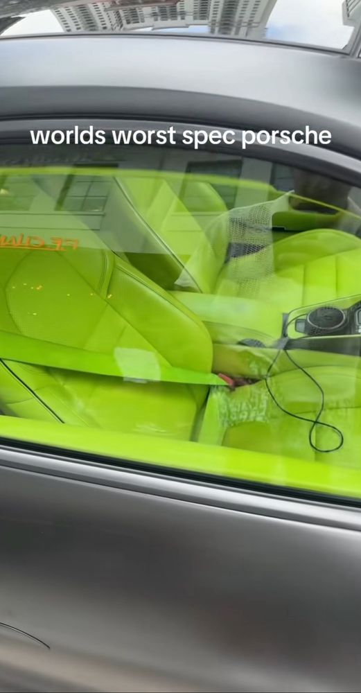 Closeup through window shows tennis ball neon yellow leather interior. Leather is cover ALL the interior surfaces except for carpets which are also neon yellow. 