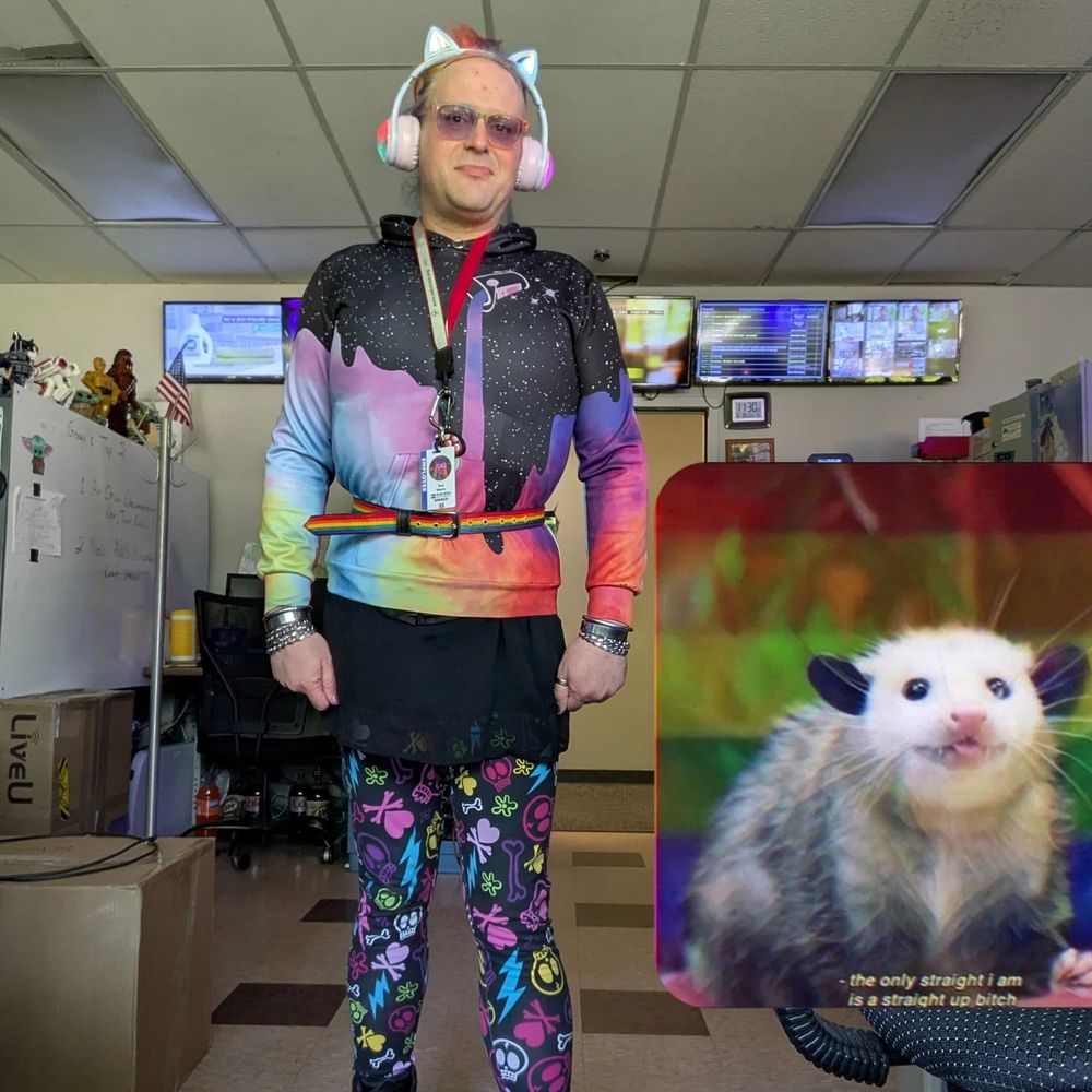 A person wearing a colorful outfit and cat ear headphones 