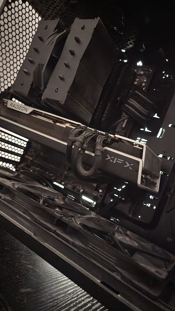 The inside of my PC. Black and grey components are exposed.