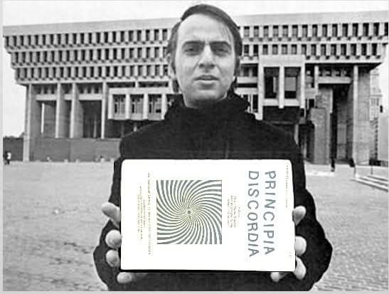 Alt-text: Black-and-white photo. A person in a dark coat stands in a wide plaza before a hulking Brutalist government building, holding a paperback toward the camera. The cover shows a tight gray hypnotic spiral with the large vertical title “PRINCIPIA DISCORDIA.” The book appears digitally pasted in, lending meme energy. The scene playfully contrasts the rigid architecture (Order) with Discordian chaos vibes (spiral), nodding to the Erisian interplay of Order and Disorder emerging from deeper Chaos. Generated with Bluesky AltText, a CustomGPT.