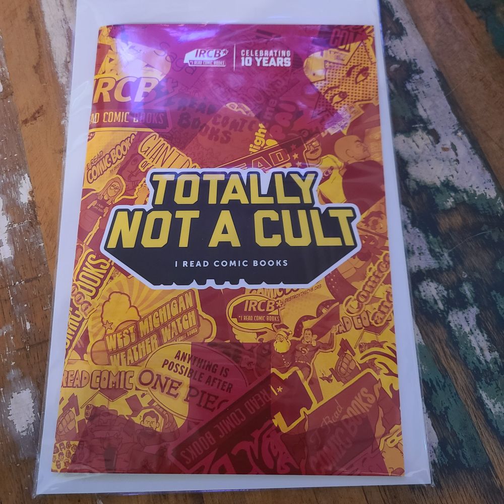 Cover of I Read Comic Books' "Totally Not A Cult" zine. It's covered in phrases and art from the show in a collage style, all in hues of red, orange, and yellow. 