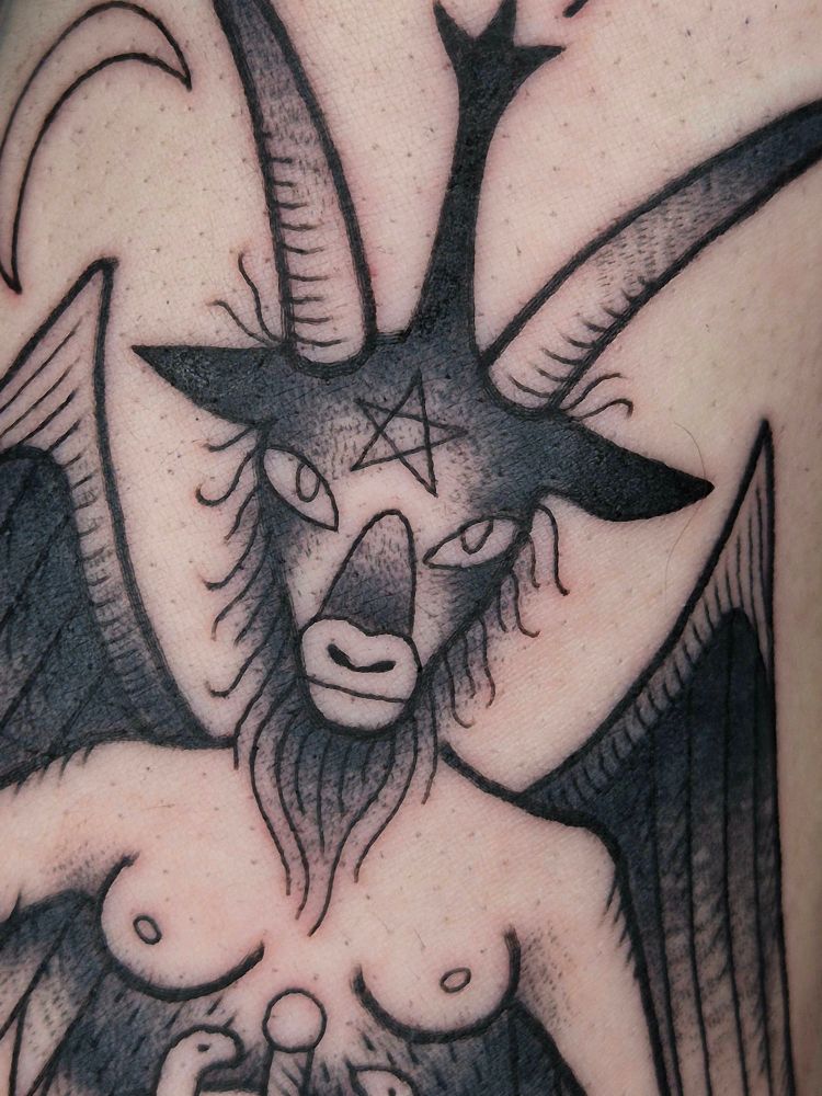 Closeup of baphomets goat head, with horns and pentagram on forehead 