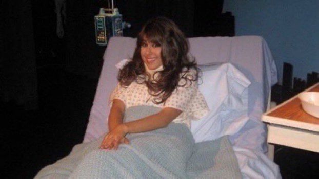 Tori Vega in a hospital bed and a neck brace looking at the camera as if saying “I’m just a baby”