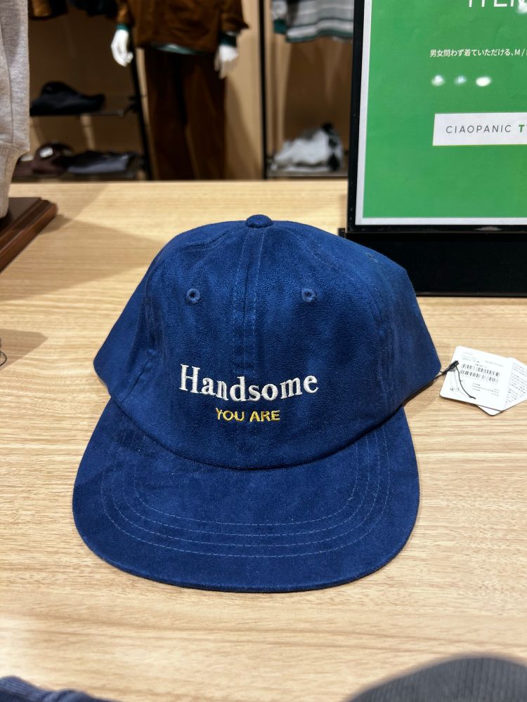 A blue suede baseball cap with the words “Handsome YOU ARE”