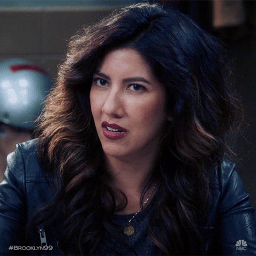 a close up of a woman 's face with #brooklyn99 on the bottom