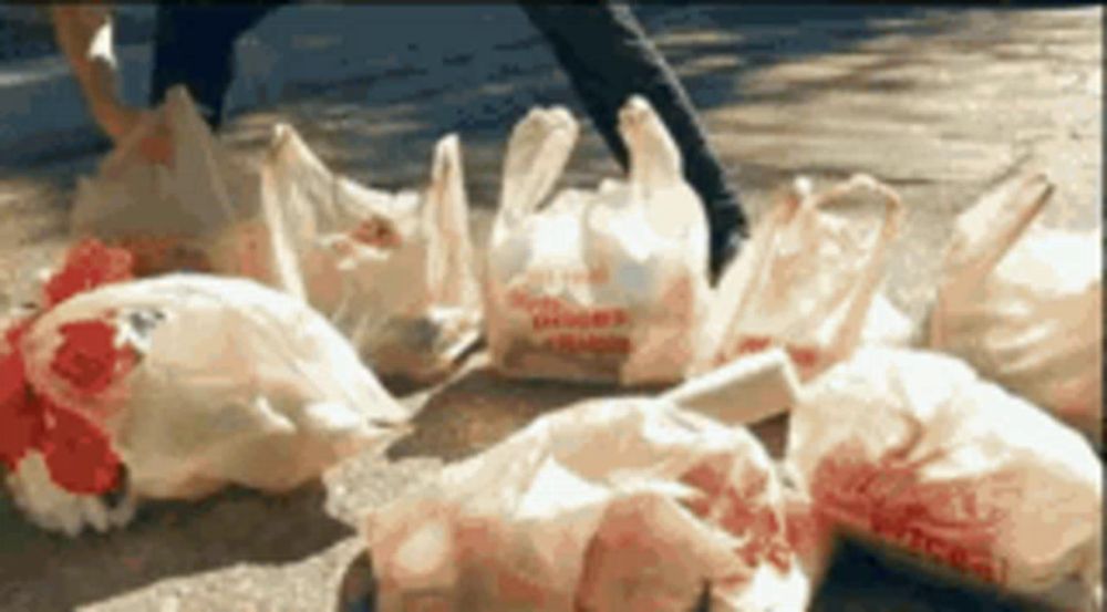 a bunch of plastic bags laying on the ground with one that says chick-fil-a on it