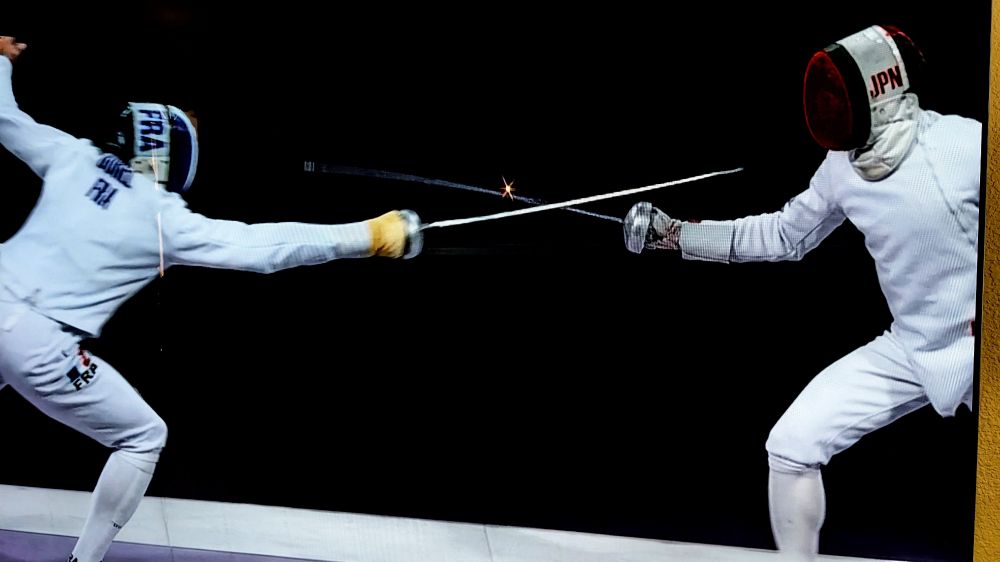 Spark coming off an Epee blade during the finals of Men's Epee at the Olympics