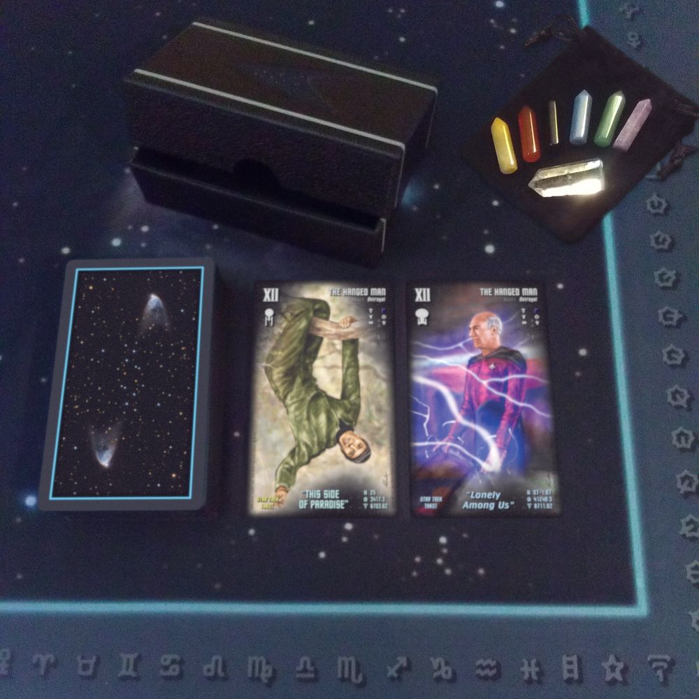 Telekiad's Star Trek Tarot, displaying its TOS and TNG The Hanged Man cards, along with a Telekiad Tarot Spread Cloth and a Telekiad Tarot Gemstone/Crystal Set.