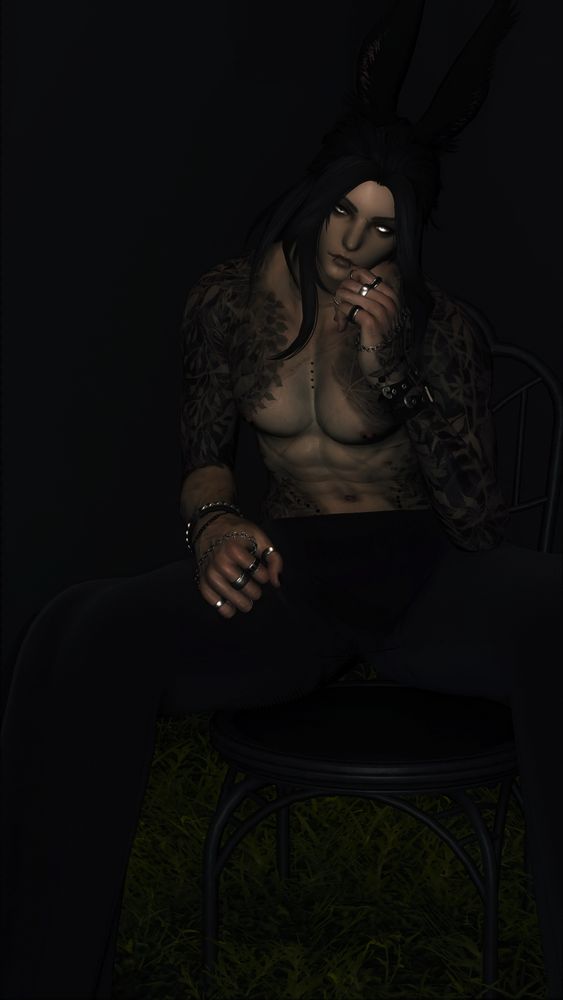 A topless male viera, sitting on a chair in the middle of grass and thinking.