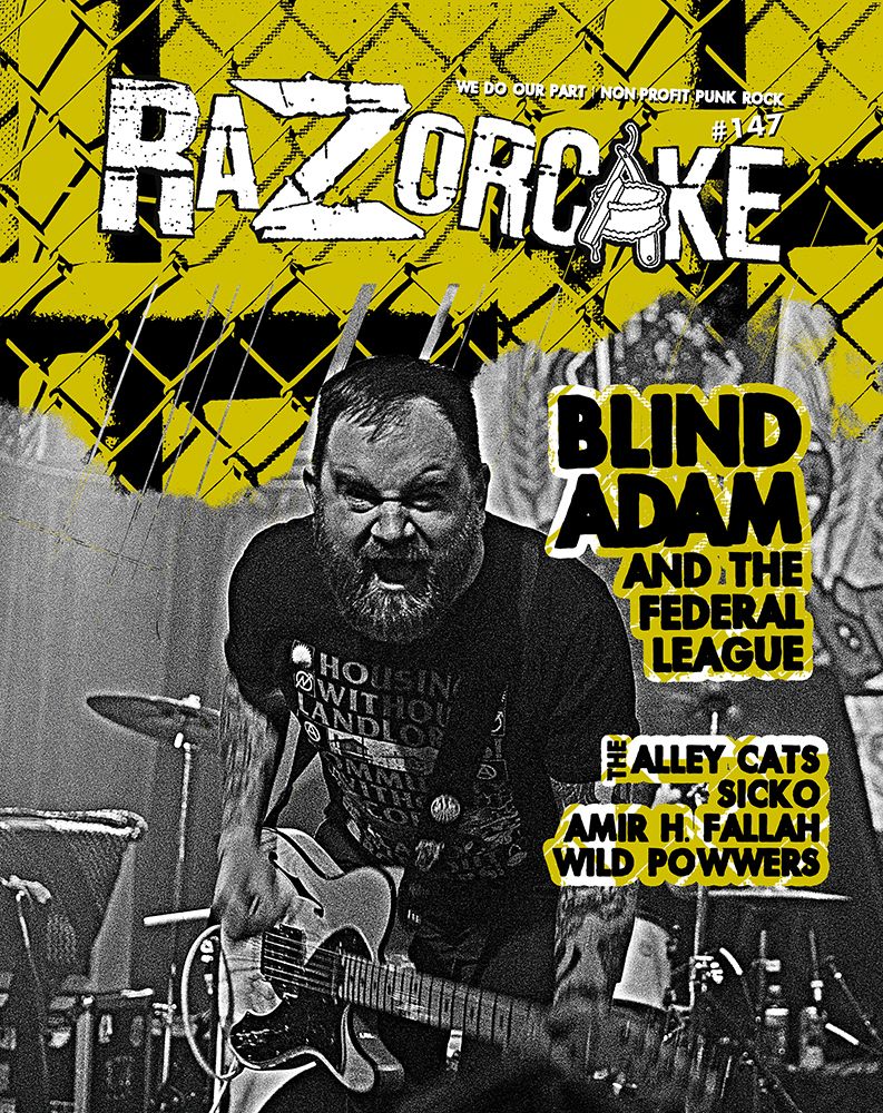 Cover of Razorcake #147. Featuring Blind Adam and the Federal League / The Alley Cats / Sicko / Amir H. Fallah / Wild Powwers.

It's Blnd Adam making a growly sinister face directly at the camera holding a guitar in front of a drumset. Yellow backgorund with a chainlink fence.