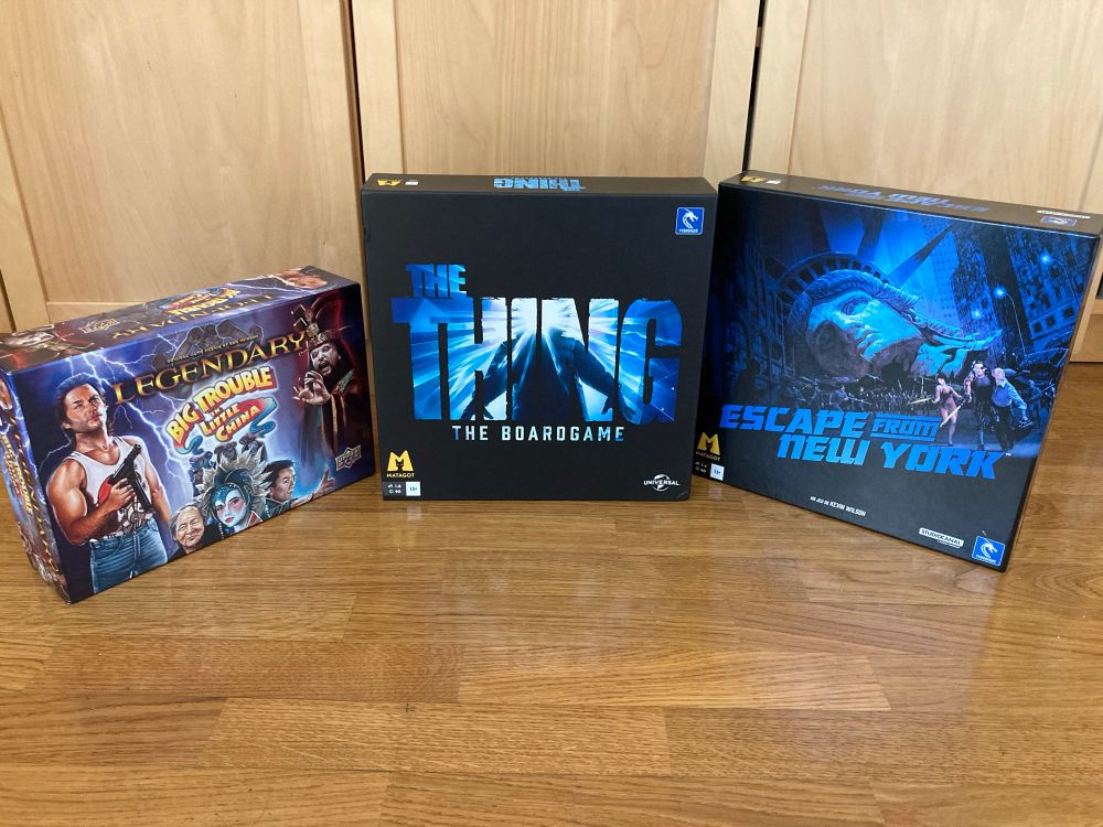 Photo de trois jeux de société adaptés de film de John Carpenter : Big Trouble on Little China (pas sorti en français), The Thing et Escape from New-York