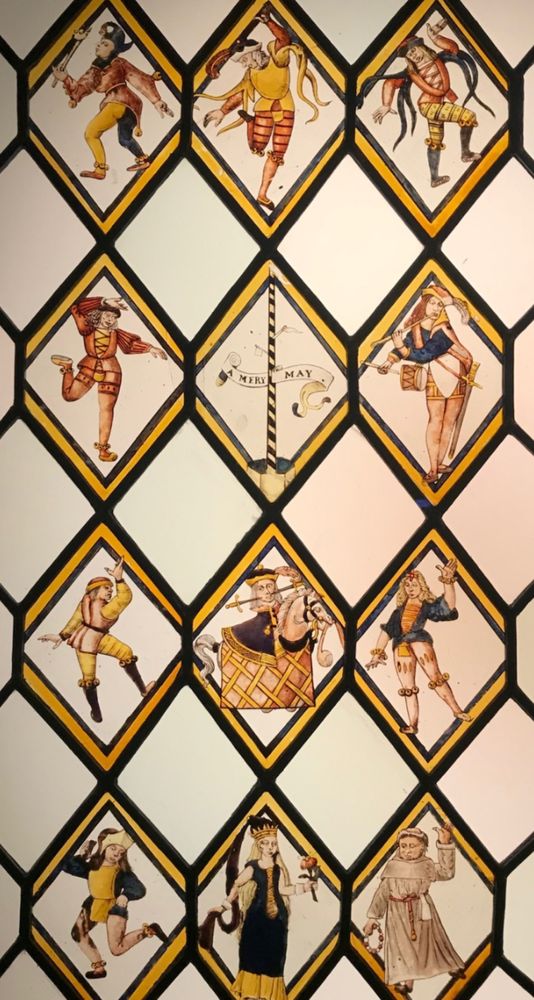 Stained glass window showing Morris dancers