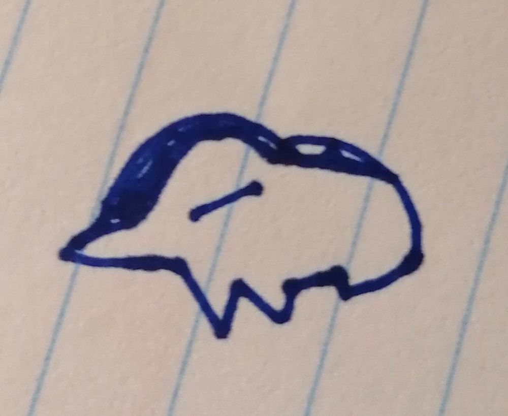 Original doodle of a tiny Cyndaquil on a notebook.