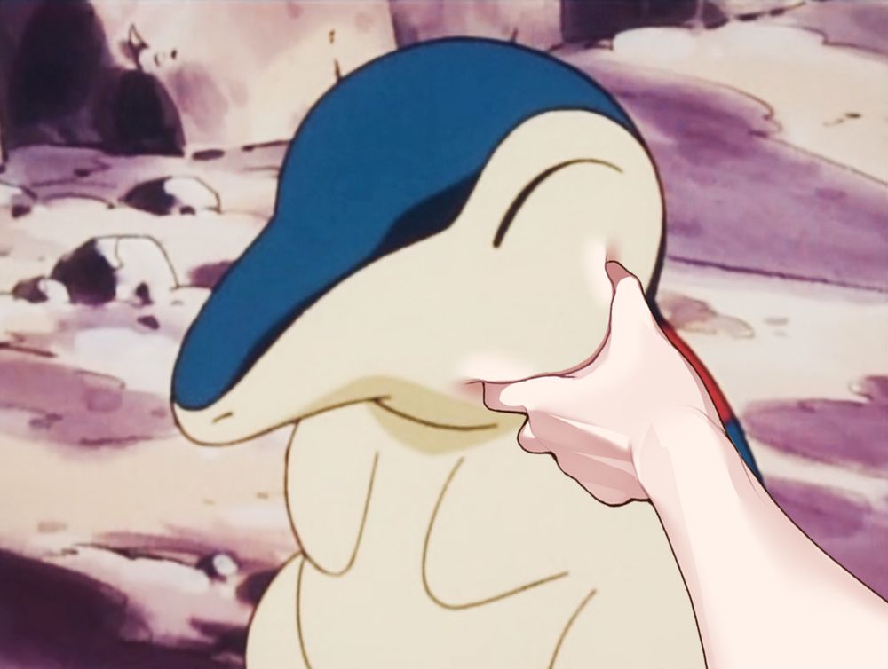 Anime Cyndaquil with its cheek being squeezed by an edited hand.