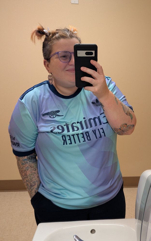 A mirror selfie in last year's light blue and lavender Arsenal jersey