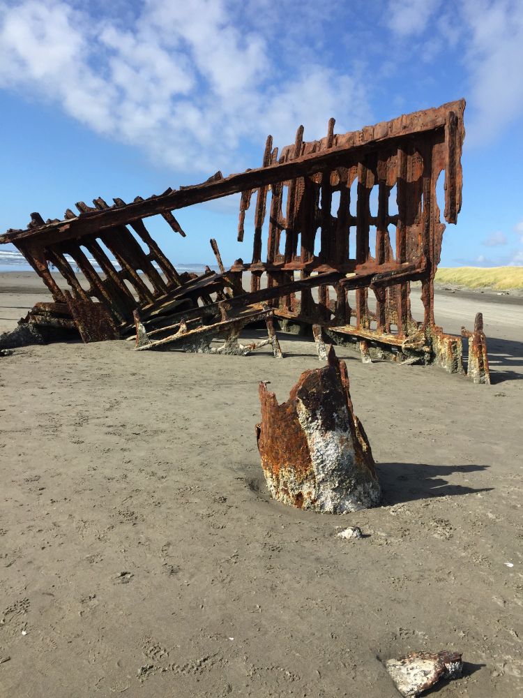 Remains of a ship wreck on a sandy beach 