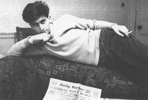 Raphael Samuel, the founder of the History Workshop Journal, reclining to the side on a sofa. In front of him is a copy of the Daily Worker.