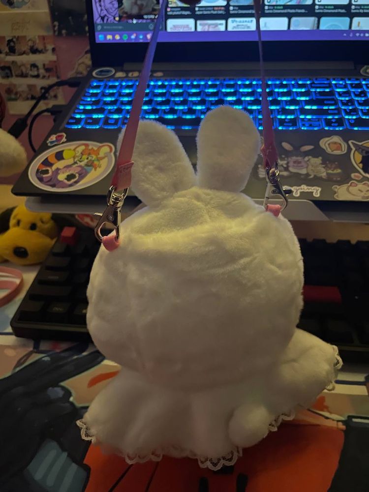 back view of sauchelle wolverine plush wearing sanrio pitatto friends small size bunny outfit. there is a little bunny tail on his bum.