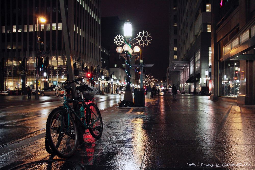 A snowy, slushy Christmas Eve on Nicollet Mall in Minneapolis, Minnesota. One is never the only person out on their bike in this awesome city. Bikes locked to pole on Nicollet Mall. Weather be damned. #photography #Minneapolis #Minnesota #peace