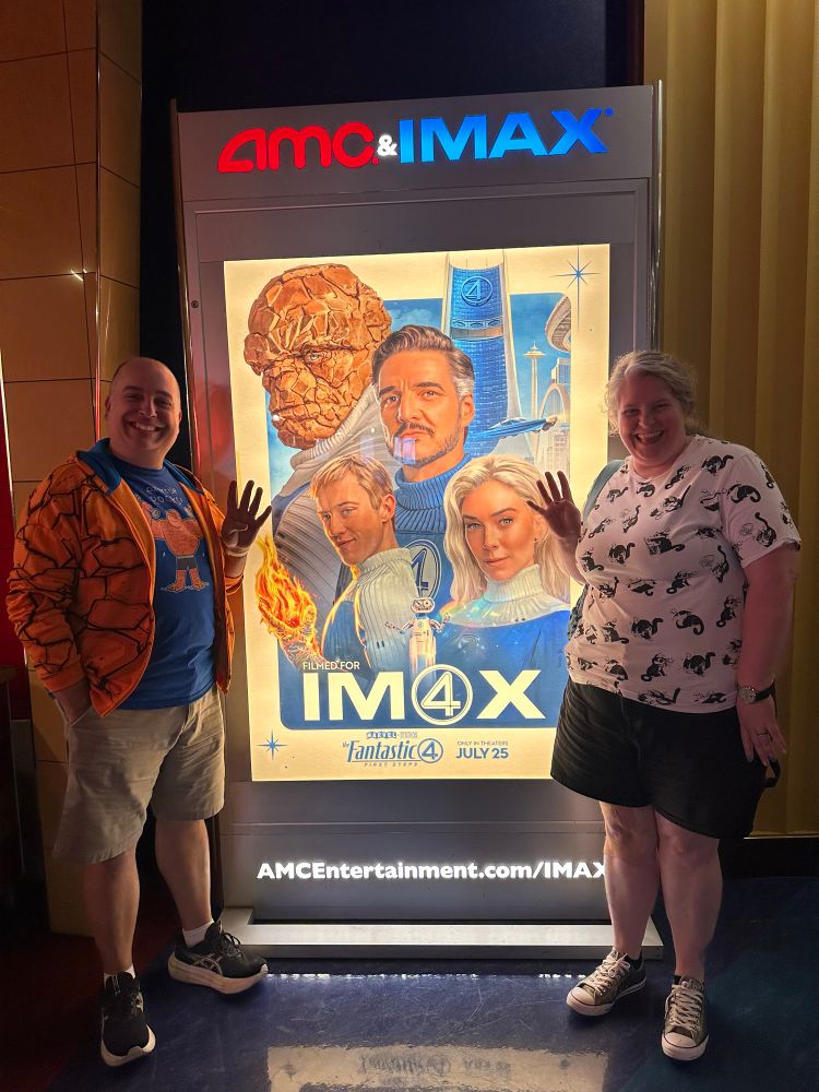 Jim and Andrea in front of a photo of the Fantastic Four movie poster 