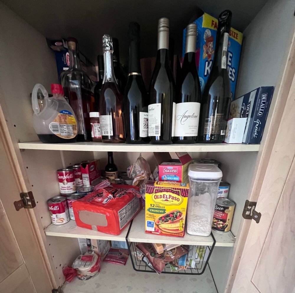 Wine closet with ramen and other salty food in it 