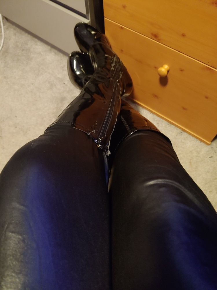 Grey carpet with black pvc boots and cat suit 
