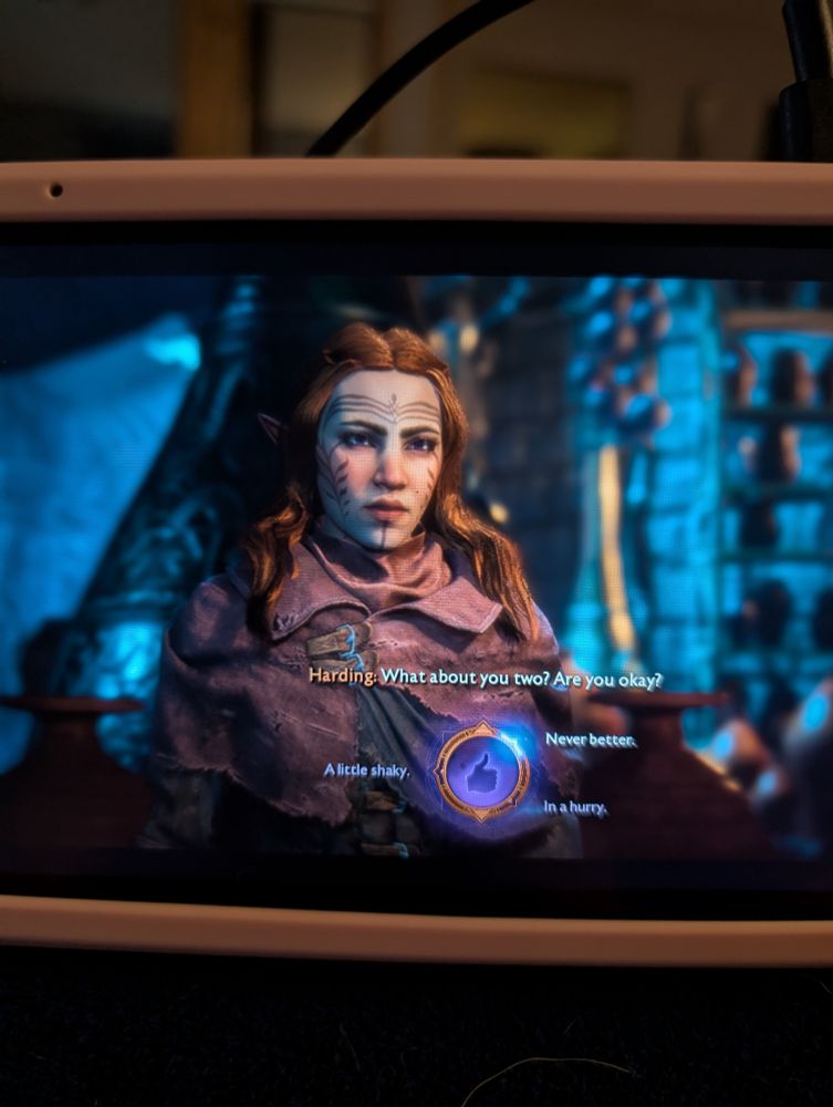 Female elf mage in Dragon Age: The Veilguard with long red hair behind a choice wheel in the beginning of the game 
