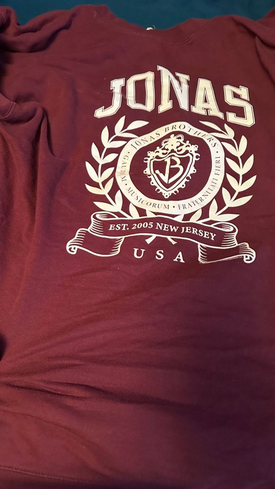 maroon jonas brothers sweatshirt with “usa” and “est 2005 new jersey”