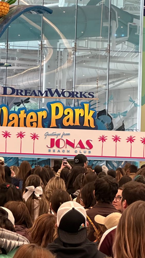a sign that says “greetings from jonas beach club”