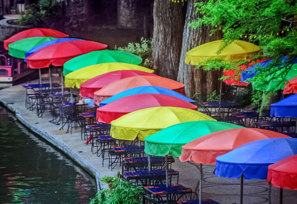 Colorful umbrellas lining the San Antonio rivet. 