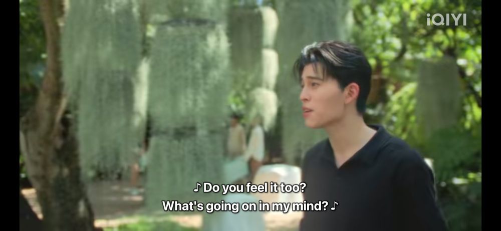 A screenshot of Me and Thee where Thee’s bursting into song on an outdoor set. The subtitles read: do you feel it too? What’s going on in my mind?