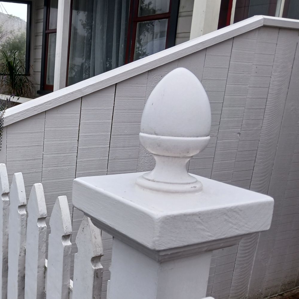 A white fencepost. Its end is supposed to be an egg cup, but it looks like a buttplug.