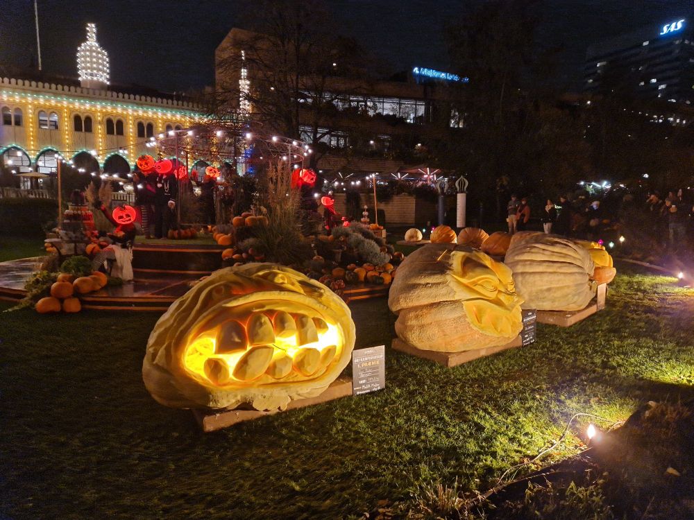 Carved and illuminated giant Halloween pumpkins exibited in front of Nimb in the Tivoli Gardens in Copenhagen, Denmark.