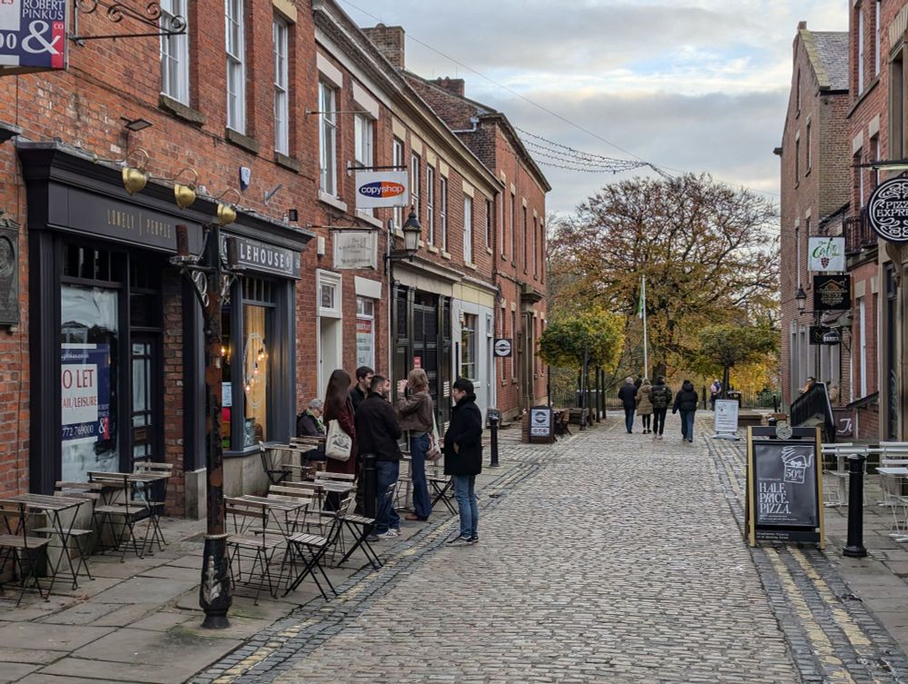 Cobbles side road with old Victorian shop frontages 