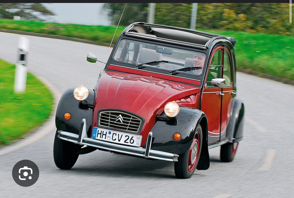 2CV fährt in einer Kurve, entsprechend in Schräglage