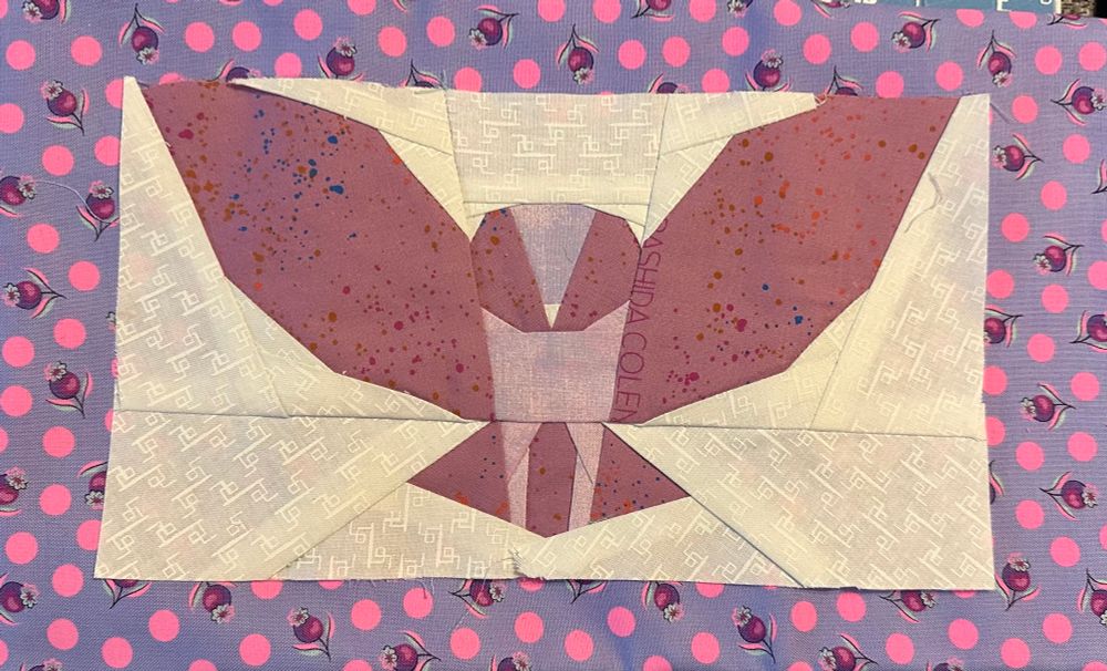 The image shows a pieced owl with wings spread.