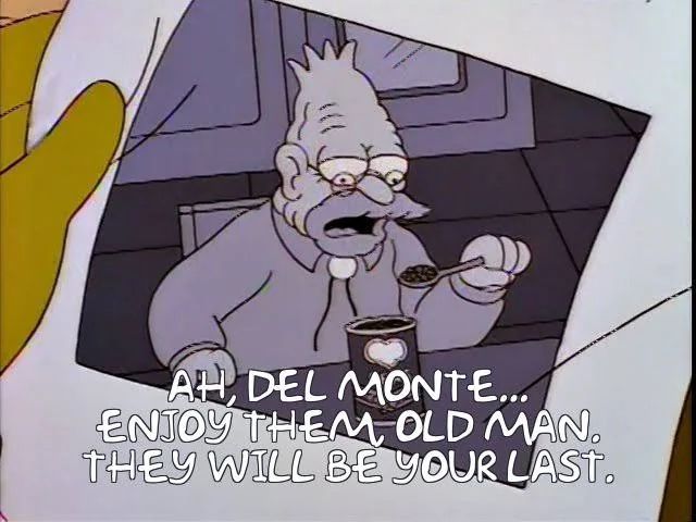 A thumb and forefinger (yellow, Simpsons-style) holding a black and white photo of an old bespectacled man in shirt and bolo tie, holding a spoon full of beans taken from a can with the heart-shaped Del Monte logo). The caption is the voice of the individual viewing the photo, stating ominously, “ah, Del Monte…enjoy them old man. They will be your last”