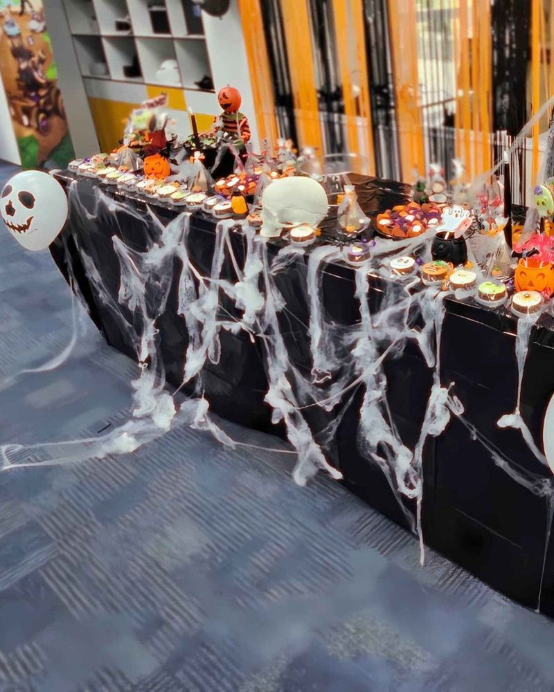 A table with halloween decorations and candies.