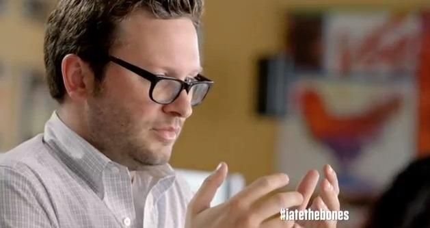 still from kfc ad of a man staring at his hands in horror like he was supposed to make Schindler's List but forgot, but what he thinks he did was that he ate the bones