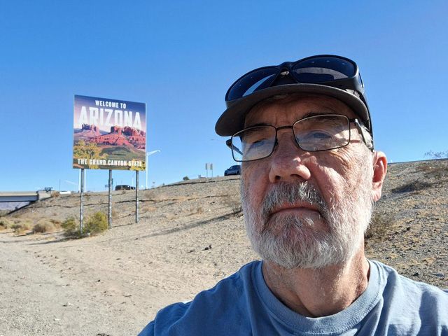 On I-10, east bound at the Arizona/California border.  My face in the foreground with the "Welcome to Arizona" border sign behind my right shoulder. 